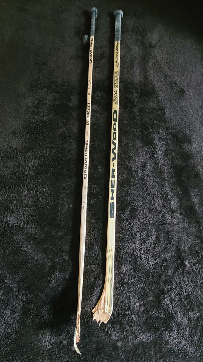Two broken John LeClair Sher-Wood sticks